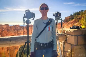 Professional photographer Audrey Cramer standing ready at Bryce Canyon's Natural Bridge for the 2023 annular "ring of fire" eclipse