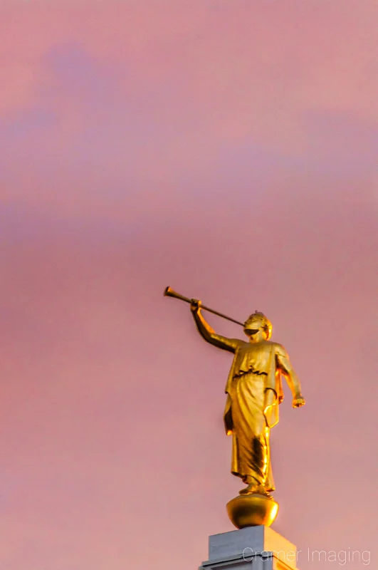 Audrey Cramer Photography's fine art minimalism photograph of the Angel Moroni statue sitting atop a spire with s pink sunset background