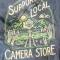 Cramer Imaging's photograph of camera related merch or merchandise, specifically t-shirt with camera-themed graphics