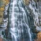 Cramer Imaging's fine art landscape photograph of Bridal Veil Falls Utah surrounded by ice and fall or autumn colors