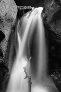 Audrey Cramer Photography's fine art landscape close-up monochrome or black and white photograph of Kanarra Falls near Kanarraville Utah with silky water