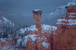 Cramer Imaging's fine art landscape photograph of a snowy Thor's Hammer hoodoo set against moody mist in Bryce Canyon National Park Utah