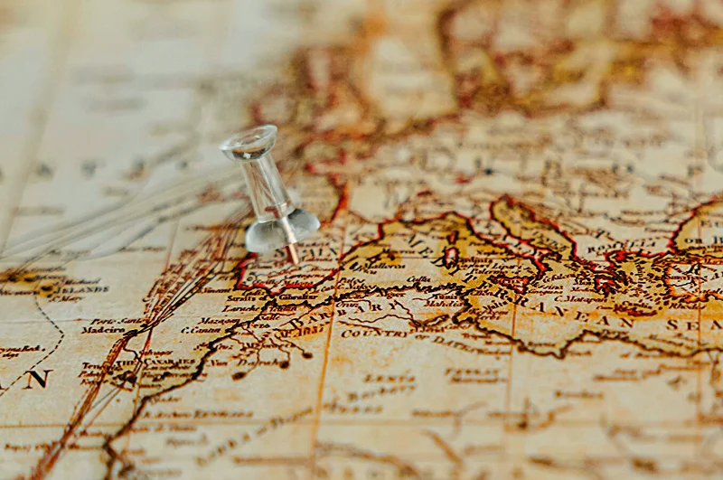 Photo of a push pin stuck into a map