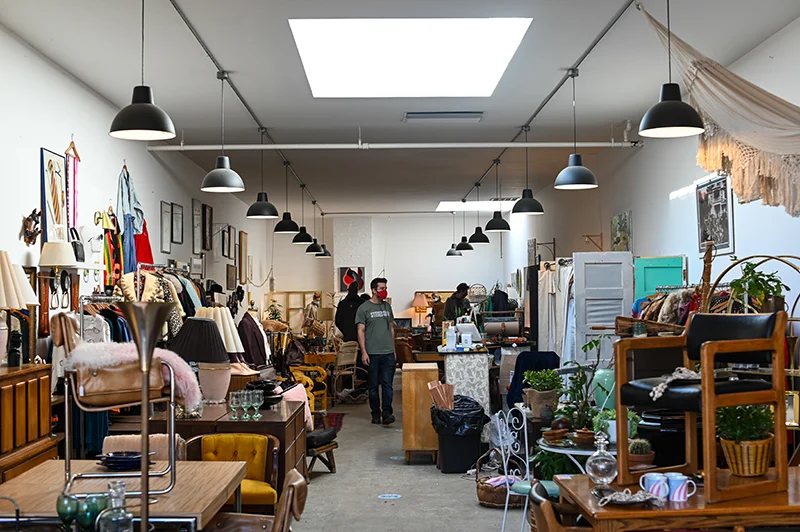 Photograph of a man in a thrift store or second-hand store