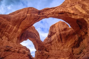 Audrey Cramer Photography's fine art landscape photograph of the Double Arch against the sky at Arches National Park, Utah