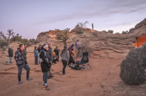 Behind-the-scenes showing a crowd gathered for early morning at Mesa Arch in Canyonlands National Park, Utah