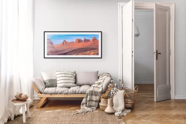 Photograph of Cramer Imaging's landscape photo "Delicate Arch Panorama" in a cozy neutral-toned living room