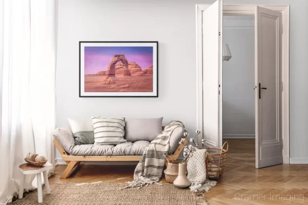 Photograph of Cramer Imaging's landscape photo "Delicate Arch Sunset" in a cozy neutral-toned living room