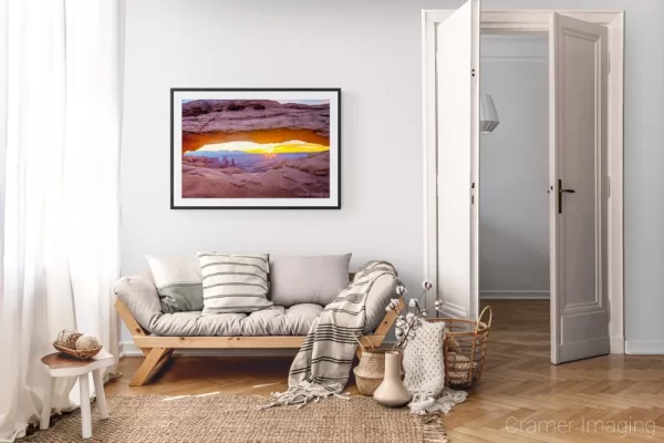 Photograph of Cramer Imaging's landscape photo "Mesa Arch Sunrise" in a cozy neutral-toned living room