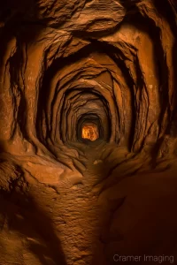 Cramer Imaging's fine art landscape photograph showing light at the end of the "Belly of the Dragon" tunnel near Kanab, Utah