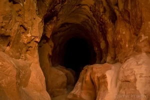 Cramer Imaging's fine art landscape photograph showing the dark tunnel of "Belly of the Dragon" near Kanab, Utah