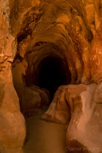 Cramer Imaging's fine art landscape photograph showing the dark tunnel of "Belly of the Dragon" near Kanab, Utah