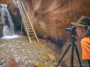 Photo of landscape photographer Audrey Cramer behind the camera at Kanarra Falls, Kanarraville, Utah