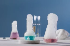 Photograph of 3 different chemical reactions in flasks in a laboratory