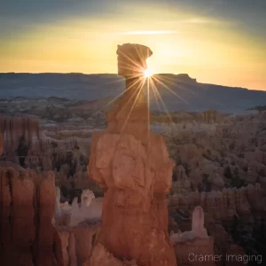 Cramer Imaging's fine art landscape photograph of the sun peeking around the Thor's Hammer hoodoo in Bryce Canyon National Park, Utah