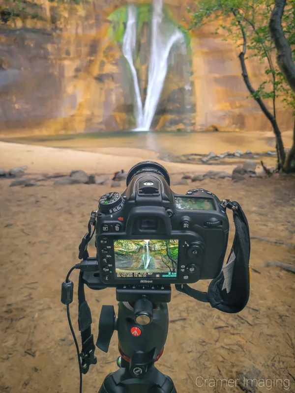 Audrey Cramer Photography's photograph of a camera on a tripod taking a picture of Lower Calf Creek Falls in Escalante National Monument, Utah