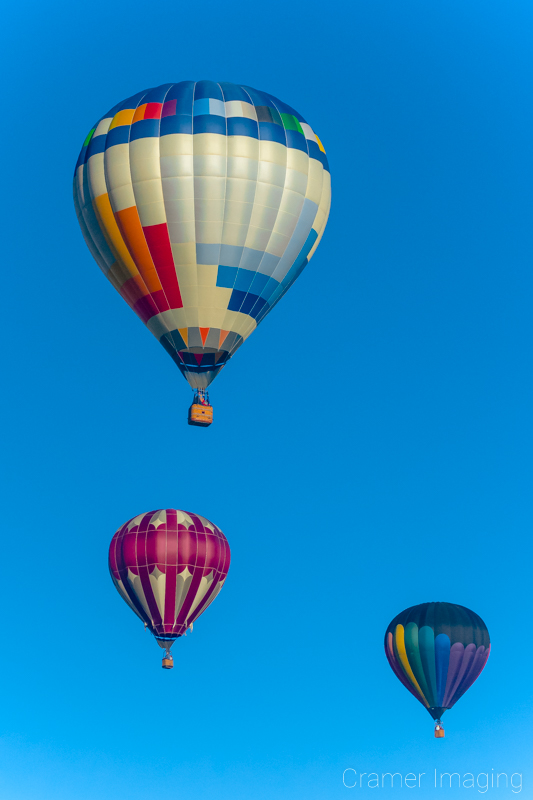 Cramer Imaging's fine art photograph of 3 hot air balloons in a clear blue sky in Panguitch, Utah