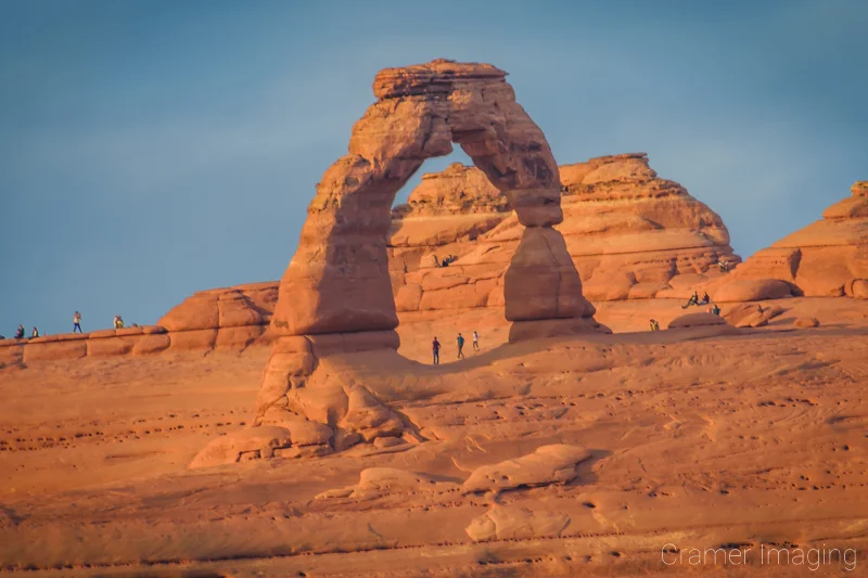 Audrey Cramer Photography's photograph of crowds of people at the Delicate Arch of Arches National Park, Utah