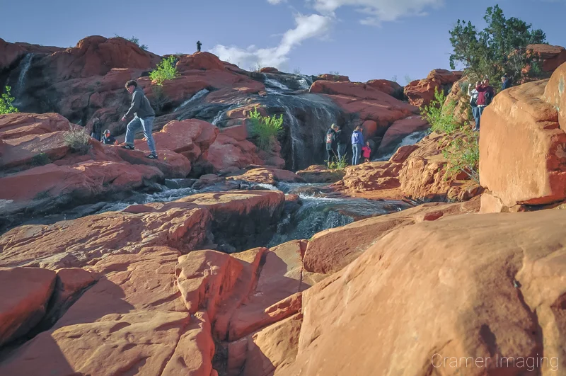 Audrey Cramer Photography's photograph of people hiking and climbing around Gunlock Falls at Gunlock State Park, Utah