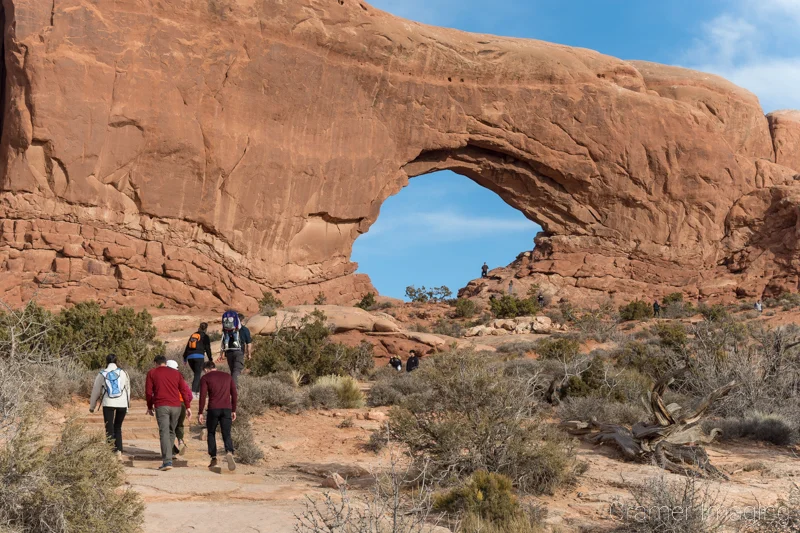 Audrey Cramer Photography's photograph of crowds of people at the North Window at Arches National Park, Utah