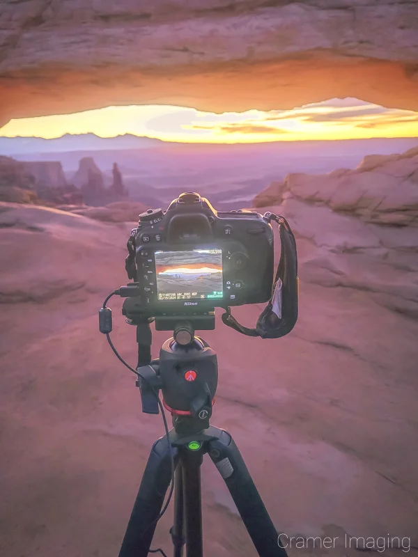 Cramer Imaging's photograph of a camera on a tripod taking a Mesa Arch picture at Canyonlands National Park, Utah