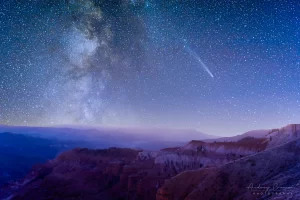 Audrey Cramer Photography's fine art landscape photograph of the Milky Way and the C/2023 A3 Tsuchinshan-ATLAS comet over a slightly snowy Cedar Breaks National Monument, Utah