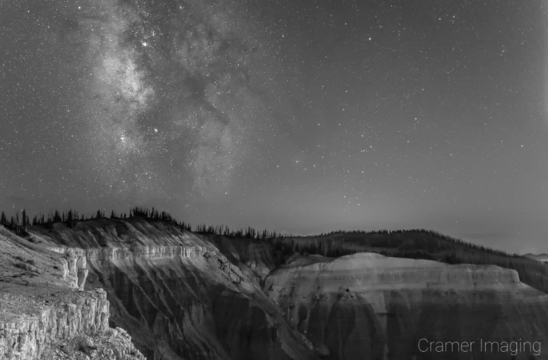 Cramer Imaging's fine art landscape photograph of the Milky Way over the cliffs of Cedar Breaks National Monument, Utah in monochrome or black and white