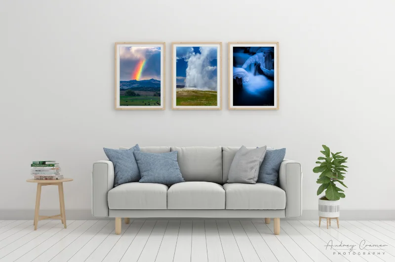 Photo of three cool-tone Audrey Cramer Photography landscape photos on the wall of a cool-tone living room