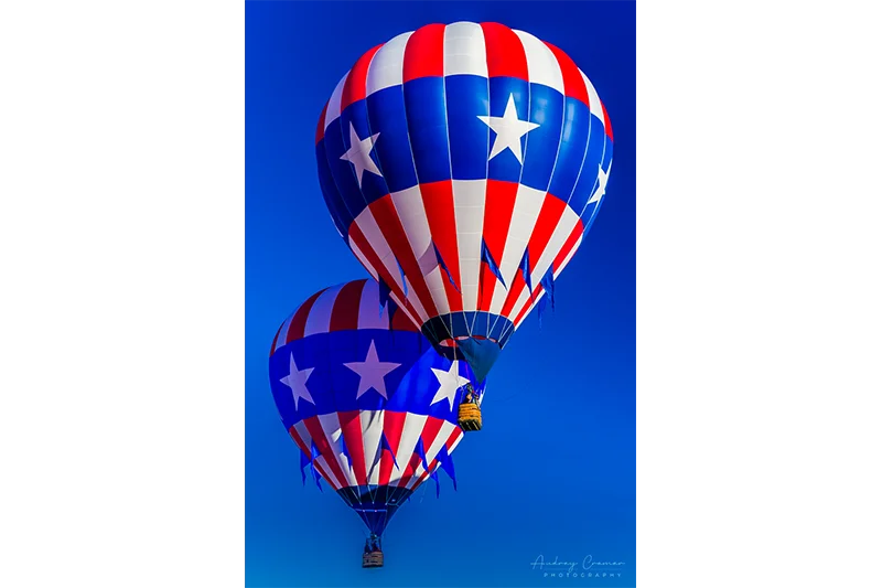 Audrey Cramer Photography's fine art photograph of two patriotic hot air balloons flying close together in the sky