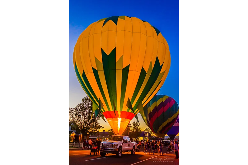 Fine art photograph of a balloon glow with 3 visible hot air balloons in Panguitch, Utah by Audrey Cramer Photography