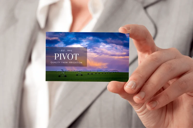 Mockup of a business card using an Audrey Cramer Photo held by a business woman
